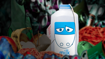 An animated still of a sad-looking milk carton in a pile of trash.